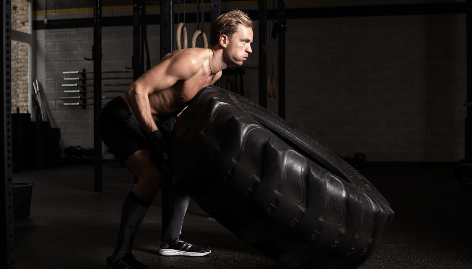 Athlete training with a large tire