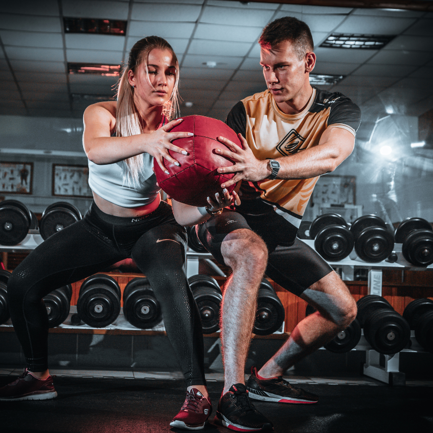 Athletes training with a medicine ball